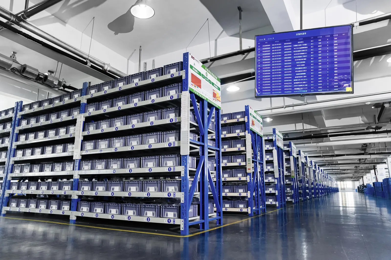 Parts warehouse with numbered storage bays — production facility scene shared by our supply partner